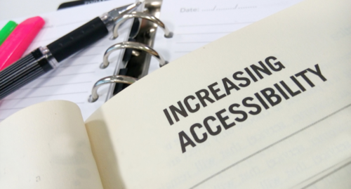 Book, binder and pens with the text "Increasing Accessibility"