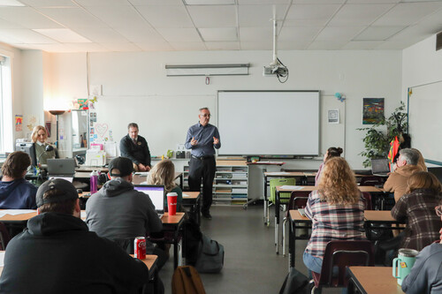 teachers in a classroom listening to a presenter